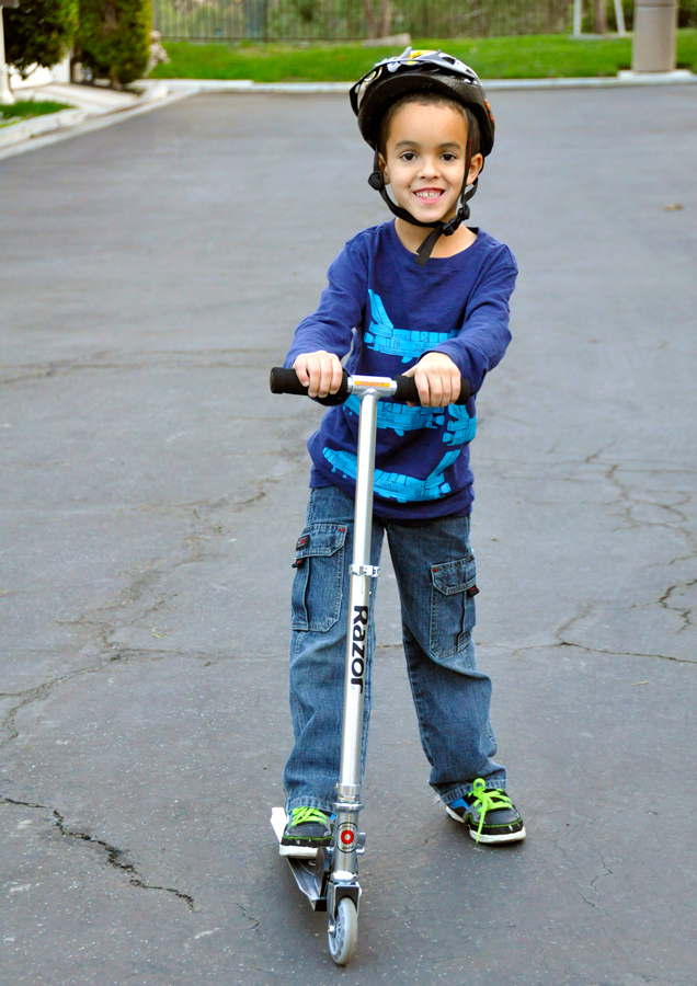 Kid riding best sale a razor scooter